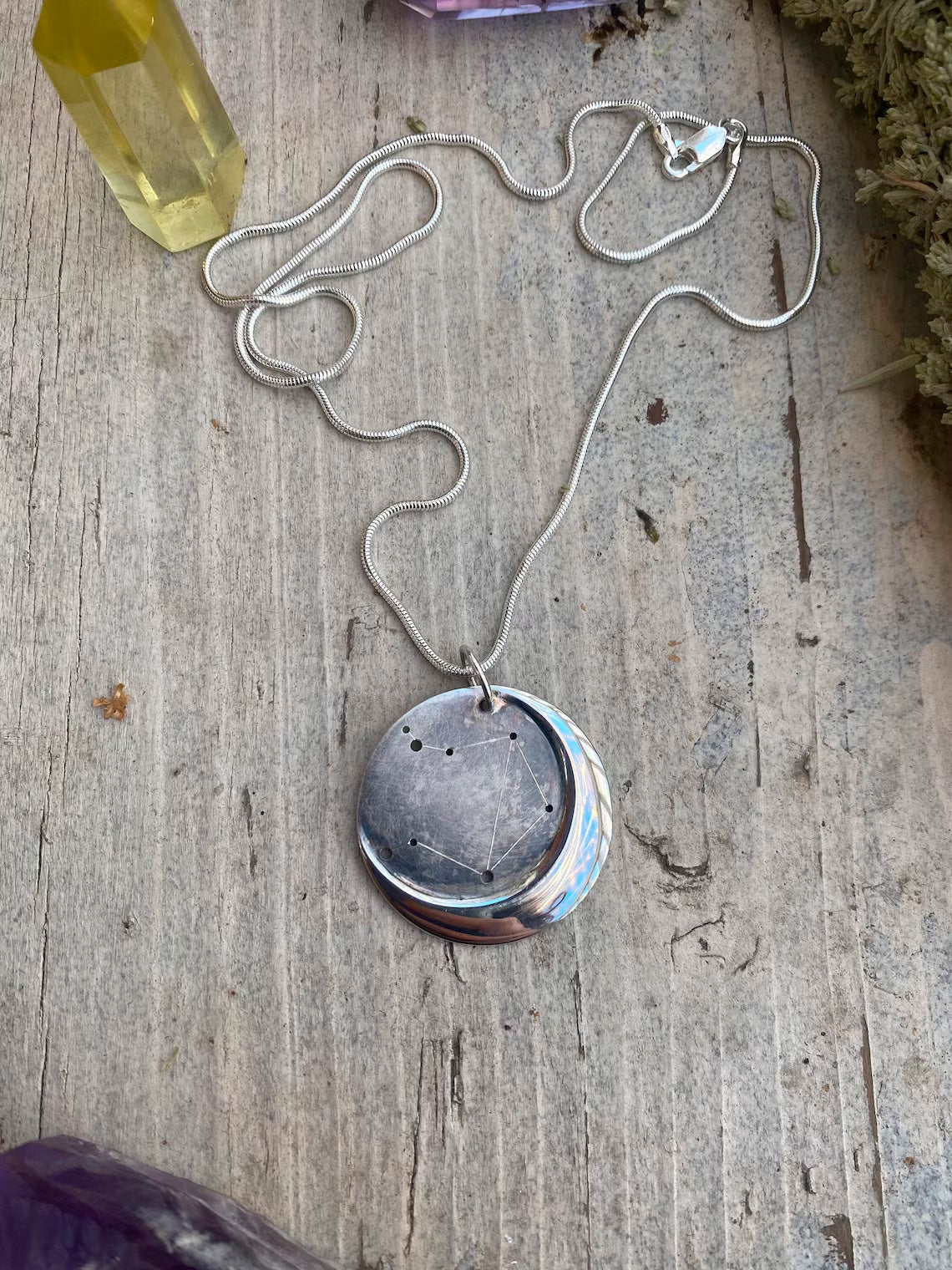 Embrace celestial beauty with our Silver Moon Zodiac Necklace. Each constellation represents a zodiac sign, custom-made just for you. Handcrafted from high-quality silver, this pendant features an oxidized night sky. The perfect birthday or holiday gift for astrology enthusiasts.