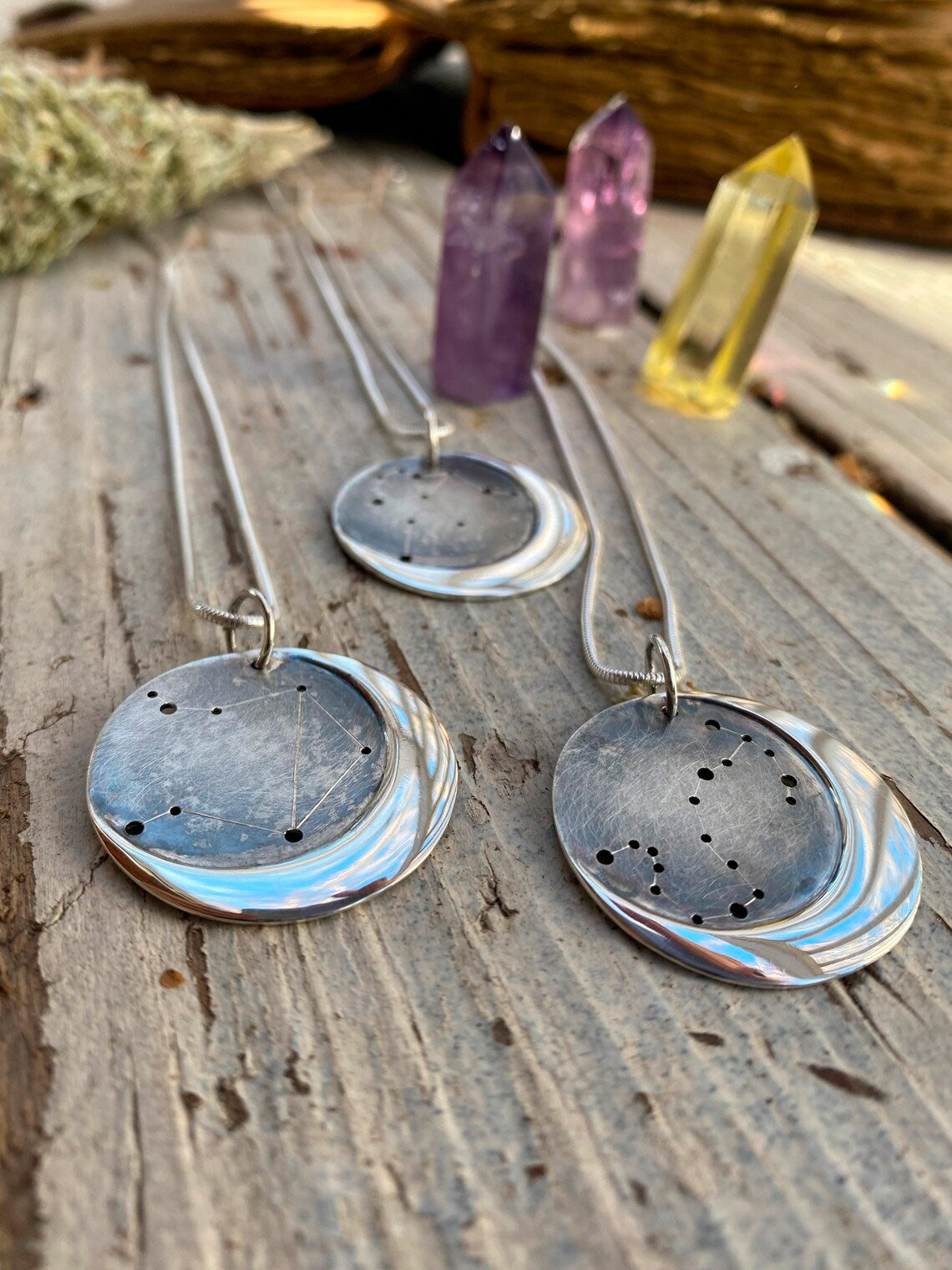 Embrace celestial beauty with our Silver Moon Zodiac Necklace. Each constellation represents a zodiac sign, custom-made just for you. Handcrafted from high-quality silver, this pendant features an oxidized night sky. The perfect birthday or holiday gift for astrology enthusiasts.
