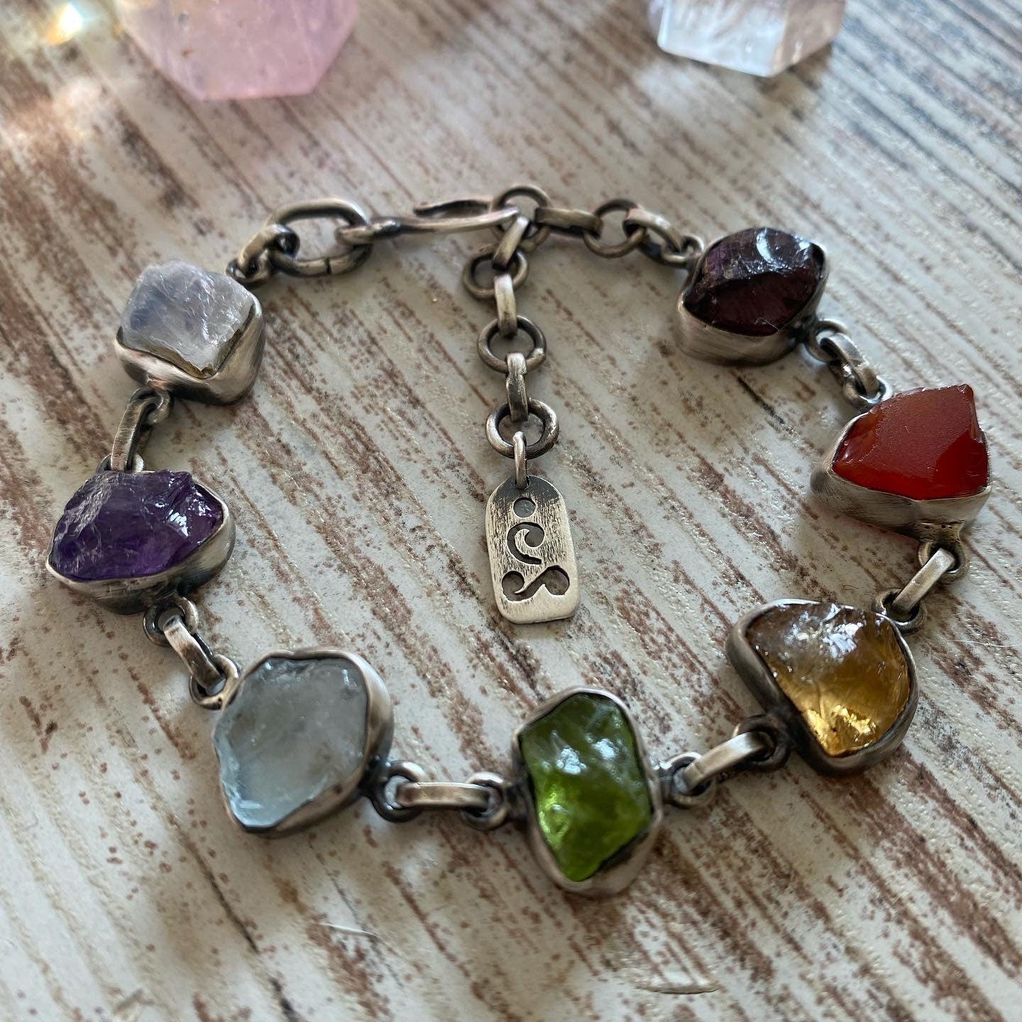 Handmade silver bracelet featuring a chakra crystal set. This unique piece includes seven natural raw stones, carefully selected to align with the seven chakras. 