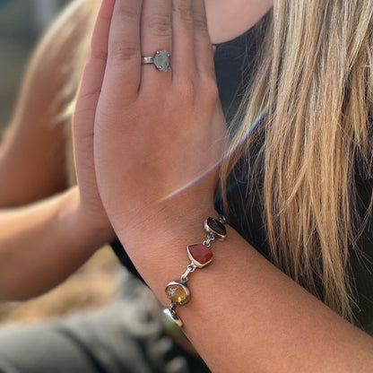 Handmade silver bracelet featuring a chakra crystal set. This unique piece includes seven natural raw stones, carefully selected to align with the seven chakras. 