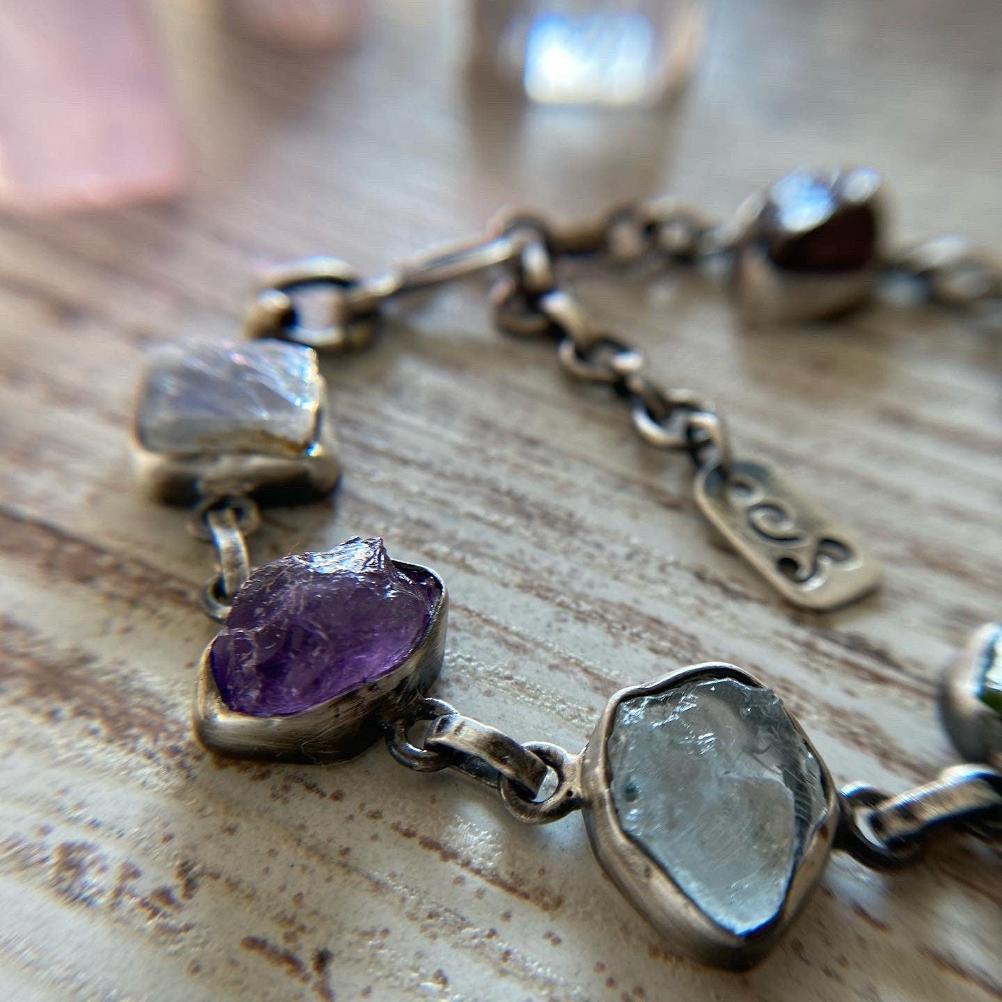 Handmade silver bracelet featuring a chakra crystal set. This unique piece includes seven natural raw stones, carefully selected to align with the seven chakras. 