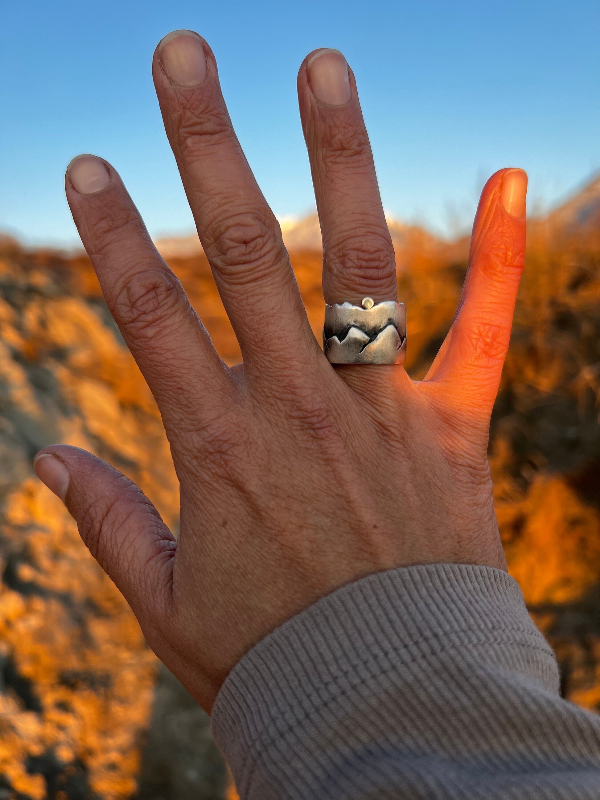 Experience the beauty of the outdoors with our solid sterling silver and 14k gold Mountain ring. Perfect for mountain enthusiasts, this special piece celebrates the adventurous lifestyle.